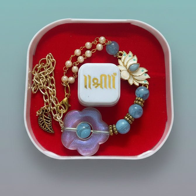 Gifthubmart Bracelet Rakhi Lotus 100C with blue beads and lotus charm in gold-tone chain, red box