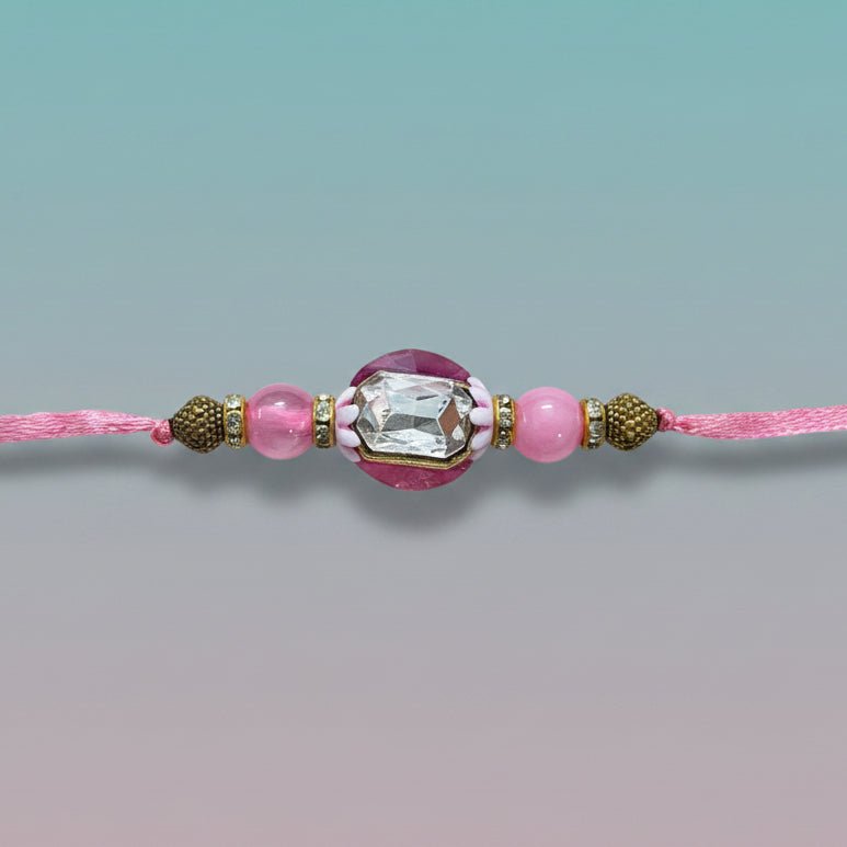 Gifthubmart Gulab Ghunghru BB Rakhi on pink cord with crystal centerpiece and pink beads