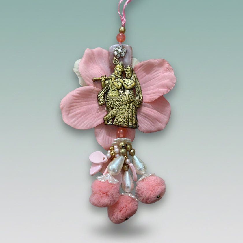 Radha Krishna Bb Rakhi by Gifthubmart; pink string with beads and brass couple charm.