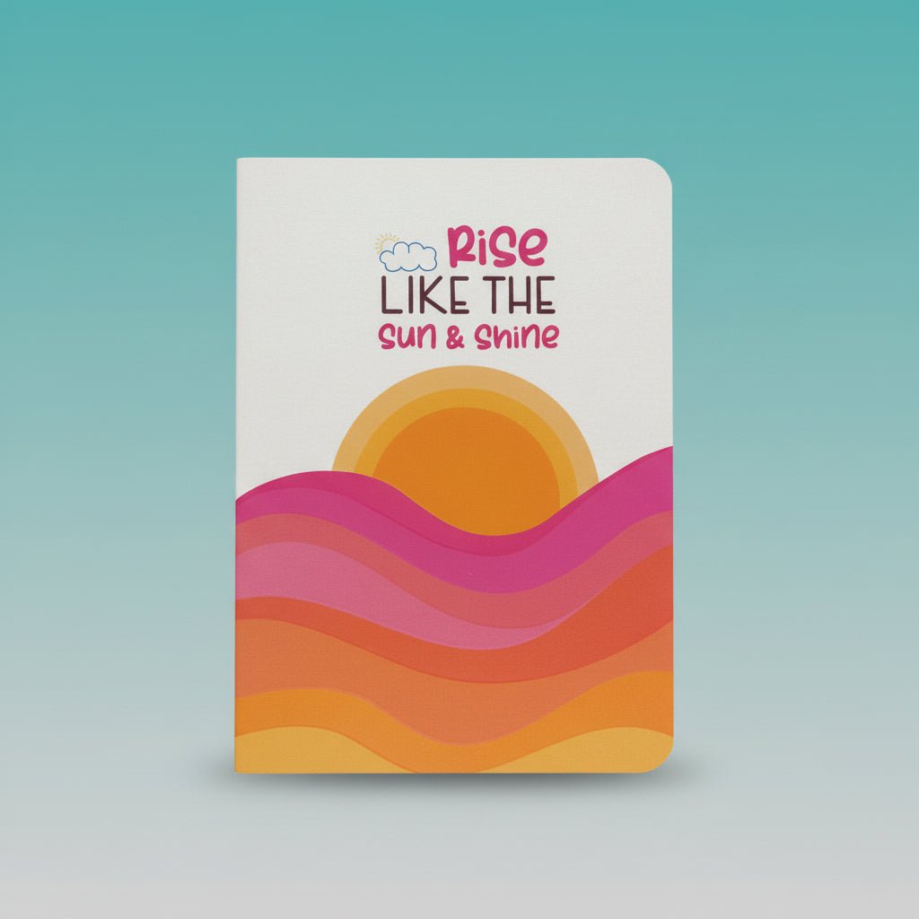 A5 Spiral Notebook by Gift Hub Mart – Rise Like The Sun & Shine with sunrise motif and vibrant waves.