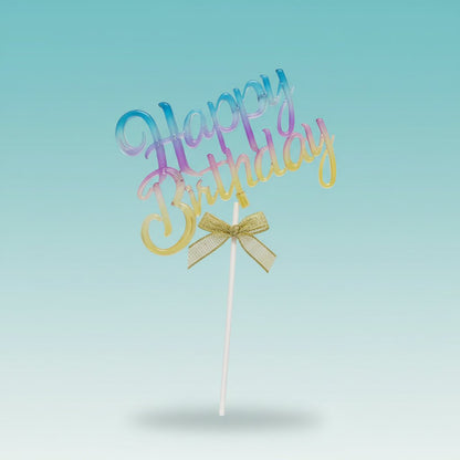 Acrylic cake topper by Gift Hub Mart in a blue-pink-yellow gradient with a gold bow