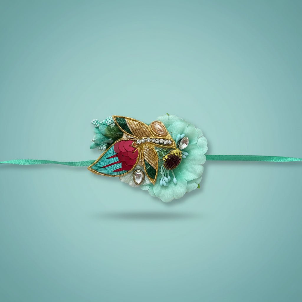Blue Pollen Rakhi by Gift Hub Mart featuring turquoise petals and gold accents