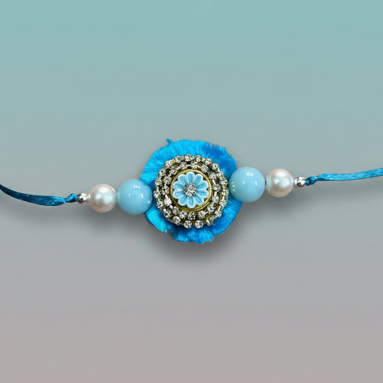Gifthubmart Blue Stone BB Rakhi with blue tassel and rhinestone centerpiece