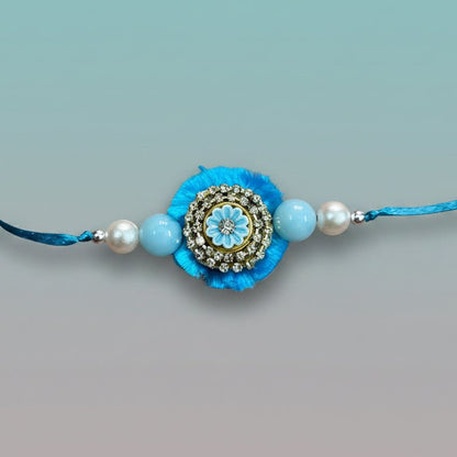 Gifthubmart Blue Stone BB Rakhi with blue tassel and rhinestone centerpiece