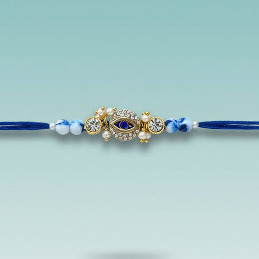 Evil Eye Blue Rakhi by Gifthubmart, blue beads with a jeweled eye charm on a blue cord