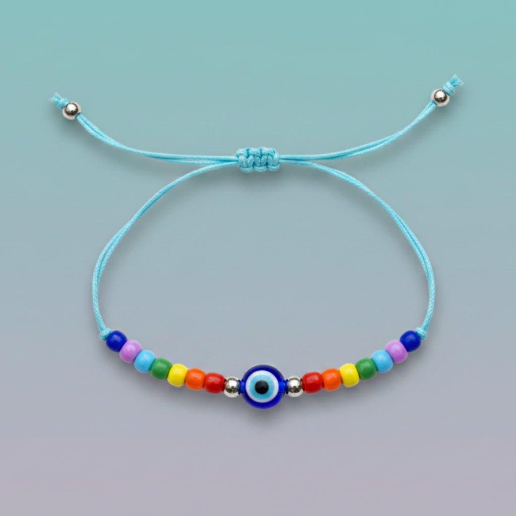 An adjustable light blue string bracelet featuring a central dark blue and white evil eye charm, accented by small silver beads and a vibrant sequence of multi-colored beads on a light teal background.