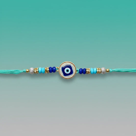 Evil Eye Teal Rakhi by Gifthubmart featuring teal thread and blue beads.