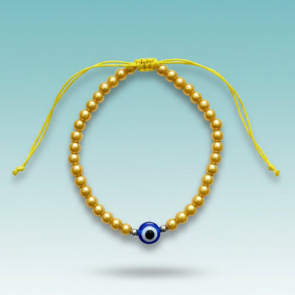 Evil Eye With Beads Bracelet featuring gold-tone faux pearls, a protective blue evil eye charm, and a yellow string closure.