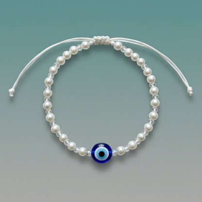 Evil Eye With Beads Bracelet featuring white faux pearls, a protective blue evil eye charm, and a white adjustable string closure.