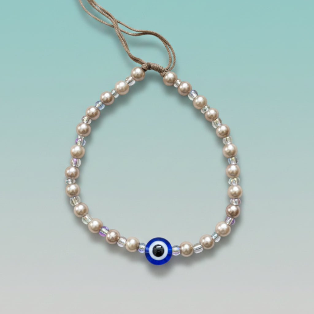Evil Eye With Beads Bracelet featuring white faux pearls and a protective blue evil eye charm.