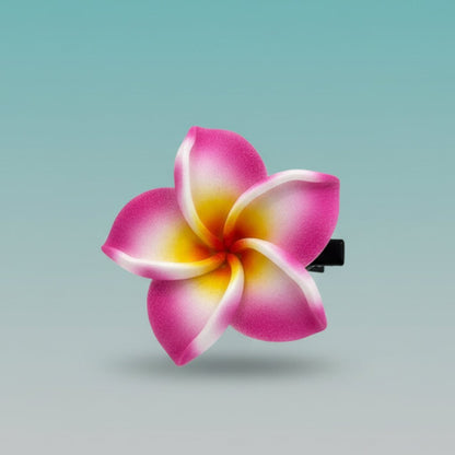 Flower-shaped hair clip with pink and yellow petals.