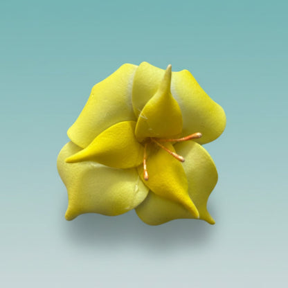 Yellow 3D fabric flower rubberband hair tie with an orange center.