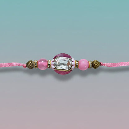 Gifthubmart Gulab Ghunghru BB Rakhi on pink cord with crystal centerpiece and pink beads