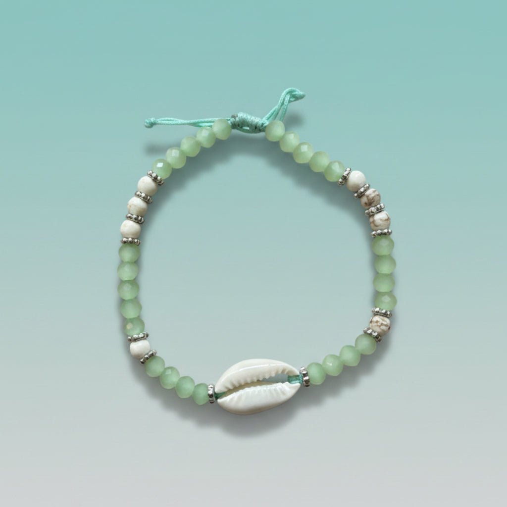 Boho-chic mint green kaudi bracelet with a smooth white cowrie shell and delicate beads