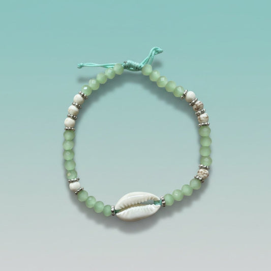 Boho-chic mint green kaudi bracelet with a smooth white cowrie shell and delicate beads