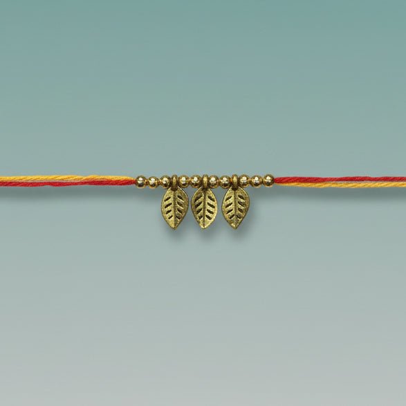 GiftHubmart Moli Rakhi Sadi on orange thread with small gold leaf charms