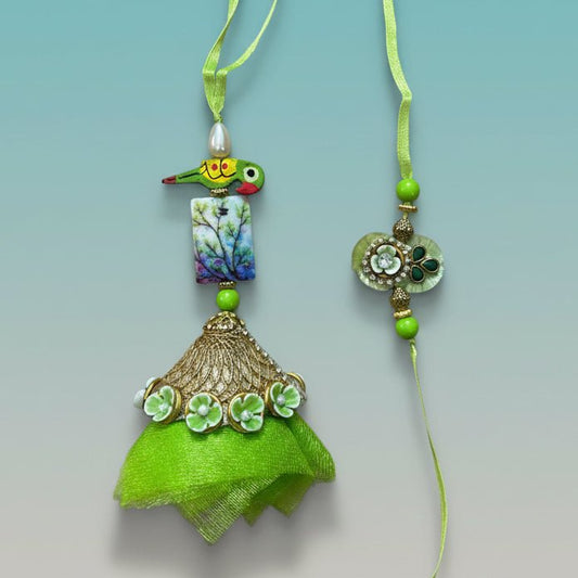 Parrot Green Bb Rakhi pair from Gifthubmart with green ribbons and decorative pendants