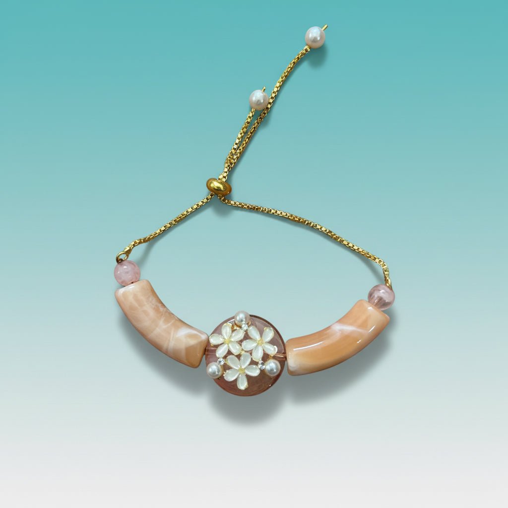 Bracelet Rakhi by Gifthubmart in peach and yellow with gold chain and pearl centerpiece