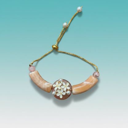 Bracelet Rakhi by Gifthubmart in peach and yellow with gold chain and pearl centerpiece