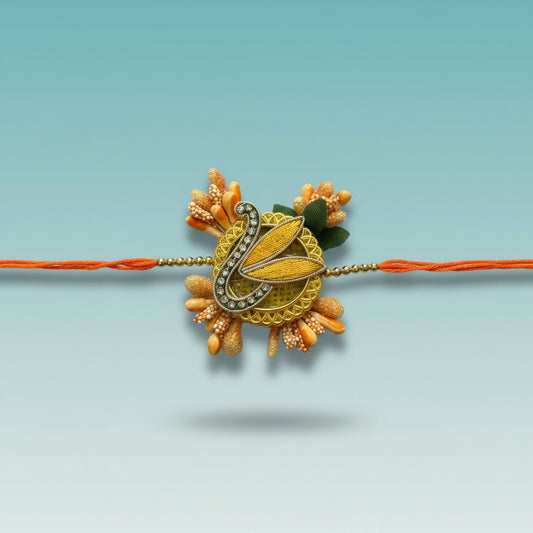 Peach Pollen Rakhi from Gift Hub Mart with orange thread and ornate pendant.