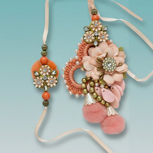 Peachy Flowers Bb Rakhi by Gifthubmart - peach floral design with crystal centers on a beaded band and ribbon