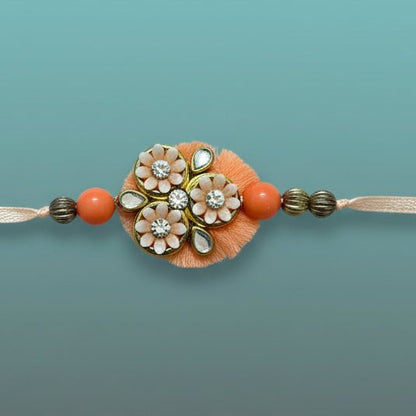 Gifthubmart Peachy Flowers Bb Rakhi with peach beads and floral charms in clear packaging