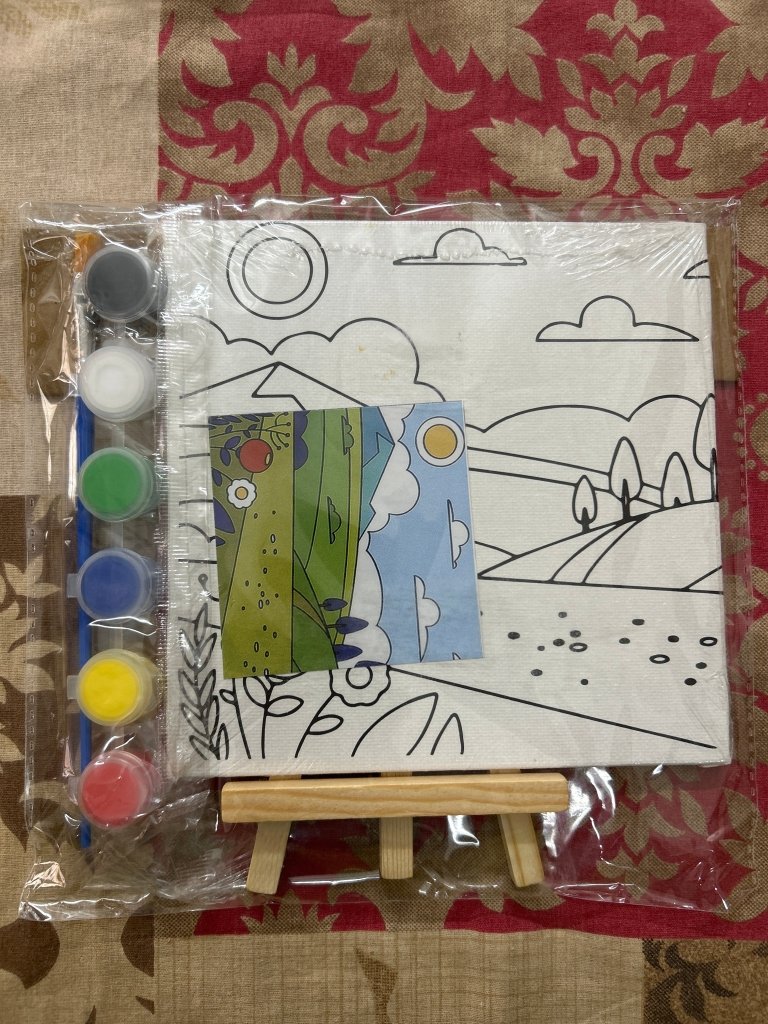 Pre Printed Canvas Easel by Gifthubmart with a colorful paint set on a wooden easel