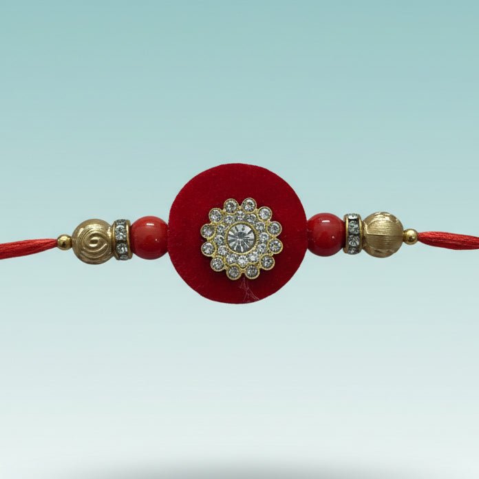 GiftHubmart Red MDF BB Rakhi with red thread and rhinestone-studded floral centerpiece
