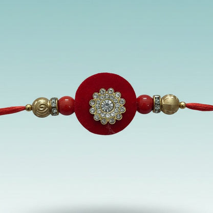 GiftHubmart Red MDF BB Rakhi with red thread and rhinestone-studded floral centerpiece