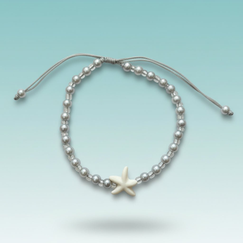 Delicate silver beaded bracelet with a white starfish charm and adjustable cord.