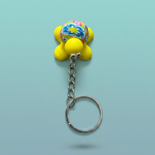 Turtle Keychain and Magnet featuring a bright yellow body and vibrant floral shell on a silver keyring.