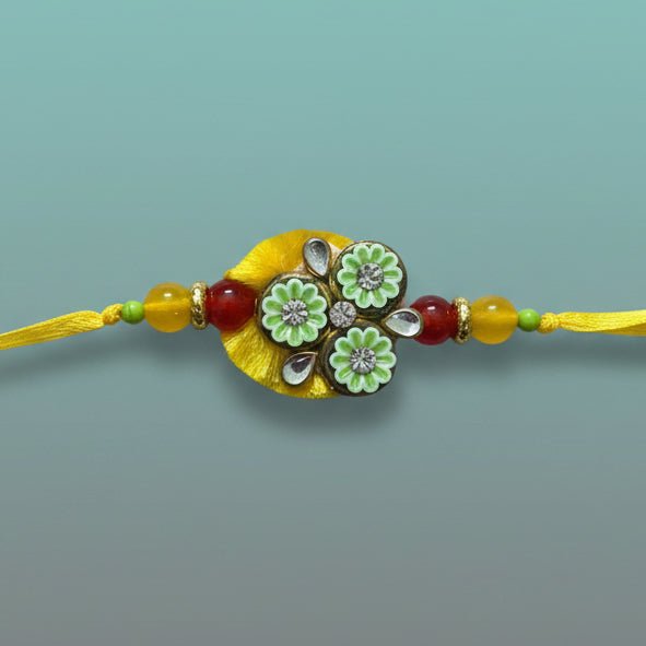 Gifthubmart Yellow BB Rakhi with beaded yellow thread and green floral centerpiece