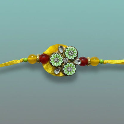Gifthubmart Yellow BB Rakhi with beaded yellow thread and green floral centerpiece